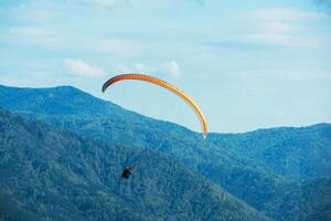 Paragliding in mountains photo