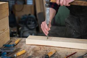 Carpenter working with a chisel photo