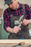 Carpenter working with a chisel photo