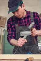 Carpenter working with a chisel photo
