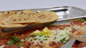 Displaying Indian Curry with Cheese and Flatbread video