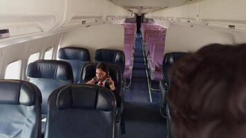 Flight Attendants Conversing in Empty Airplane Cabin video