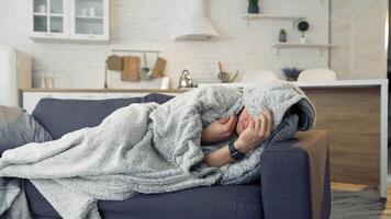 Man feeling sick on the couch at home with cold and flu symptoms. Pandemic. video