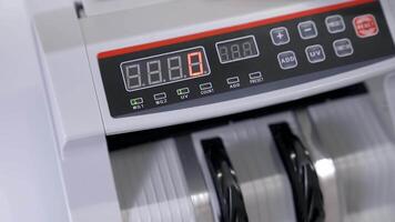Cash money counting machine. Banknote counter are counting hundred dollar bills. Close-up video