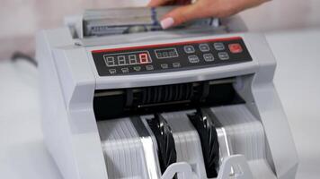 Money counting equipment for paper money calculation. Automatic mechanism for bank financial operations. Currency exchange of one hundred usd. Closeup currency counting machine counting dollar bills video
