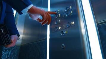 Man hand presses floor buttons in elevator. Unrecognizible man in suit pushes floor button. Selective focus. video