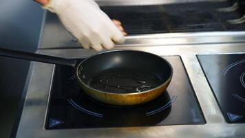 Bacon slices in frying pan. Man hands put bacon on frying pan. Unhealthy food. video