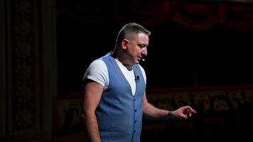 Actor on classic theatre stage. Man is speaking in spotlights during the performance. Side view . video