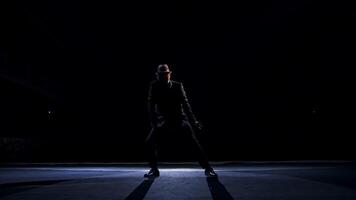 Senior man in costume on stage in darkness. Active man in hat dancing on stage during the performance in the theater. video