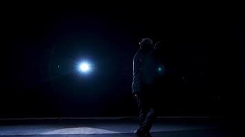 Senior man in costume on stage in darkness. Active man in hat dancing on stage during the performance in the theater. video