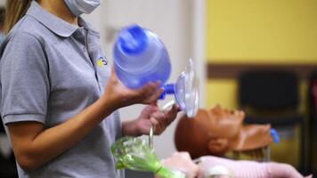 Medic is using CPR technique on dummy in first aid class. Oxigen mask on medical doll demonstration. Training courses. video