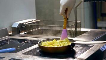 Cooking and stirring pasta in frying pan. Pasta with sauce turned with spatula in a frying pan. Cooking dinner concept. video