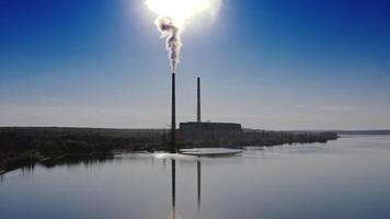 Smokestack in factory with blue cloudless sky. Sunset above modern factory. Panoramic with drone. video