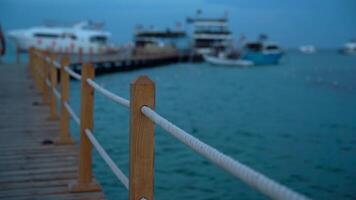 Empty wooden pier in cloudy weather near boat parking video