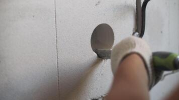 Creating a hole in a gas block wall for electrical wiring video