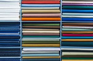 Layers of different fabrics with different colors in the stack. photo