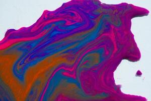 Multi-color paint drops and splotch on white background photo