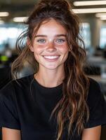 Portrait of a smiling young woman with freckles and long wavy hair photo