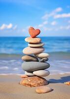Balanced stones with red heart on beach photo