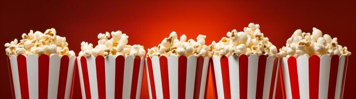 delicious popcorn in red and white striped boxes photo