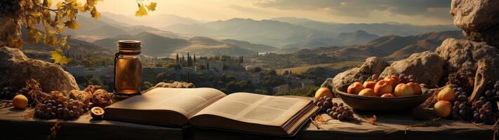 Autumn landscape with open book, fruits, and mountain view photo