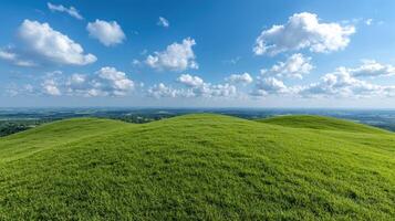 Rolling green hills under a bright blue sky with fluffy white clouds photo