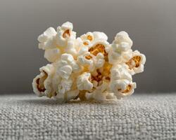 Close up of a pile of popcorn on a textured surface photo