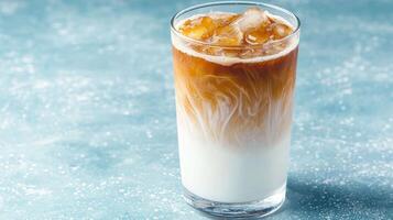 Iced coffee with milk in a tall glass photo