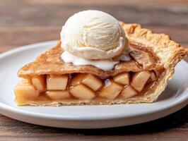 A slice of warm apple pie with a scoop of vanilla ice cream photo