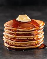 Stack of fluffy pancakes with butter and syrup photo