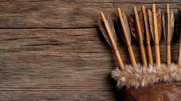 Wooden arrows in a leather quiver on a rustic wooden background photo
