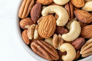 Close up of a bowl of mixed nuts, including almonds, cashews, and pecans photo