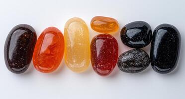 Collection of colorful tumbled stones arranged in a row photo