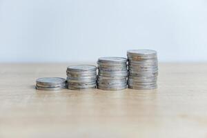 Close-up photo of a pile of coins on a table with a white background