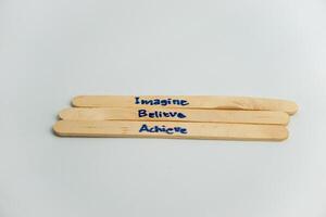 handwriting messages on ice cream sticks in close-up as a concept for building self-esteem photo