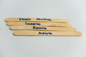 handwriting messages on ice cream sticks in close-up as a concept for building self-esteem photo