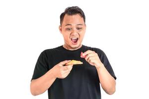 Enjoying a Delicious Slice of Pizza in a Black T-Shirt photo