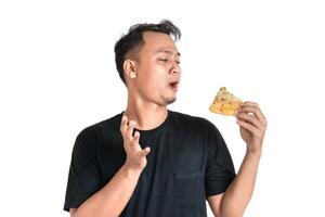 Man Enjoys a Slice of Pizza with Curious Disbelief on a White Background photo