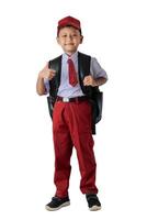 A Indonesian student in a red and white uniform with a backpack, giving a thumbs up on a white background. photo
