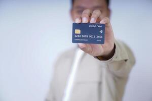 A person holding a credit card, showcasing its features and design for a photo. photo