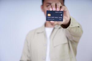 A person holding a credit card, showcasing its features and design for a photo. photo