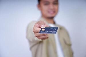 A person holding a credit card, showcasing its features and design for a photo. photo