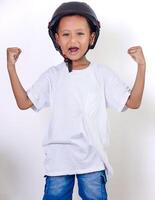 A cheerful asian child wearing a helmet, celebrating with raised fists and a bright smile. photo