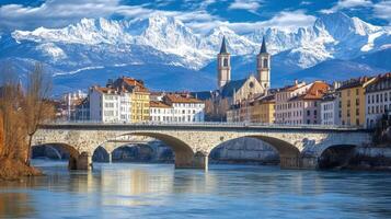 Alpine Cityscape with Snowy Mountains and Bridge photo