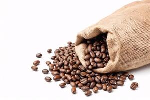 Coffee beans spilling from burlap sack. photo