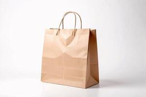 Brown paper bag with twisted paper handles on white background. photo