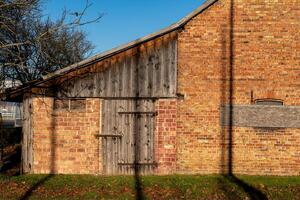 Old barn structure showcasing rustic charm in bright sunlight photo