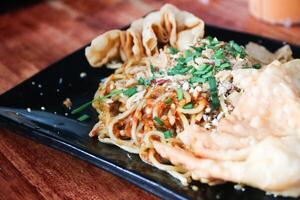 Gacoan noodles are a popular food in Indonesia. Made from noodles served with spicy spices and fried dumplings. photo