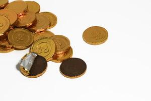 Chocolate coins. Brown coin money background on brown background. Coins are stacked on top of each other in different positions. Bunch of coins. photo