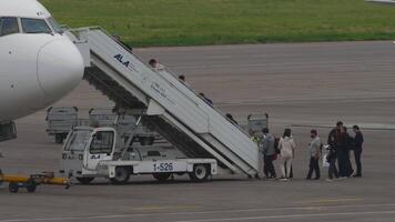 ALMATY, KAZAKHSTAN - MAY 10, 2024. Group of people standing in queue at boarding plane. Boeing 767, EI-KEC of Air Astana aircraft using the mobile stairway at Almaty airport video